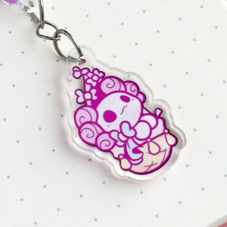 Cute axolotl keychain showing Evy's original cartoon character, Lottie the Lotl, travelling in a hot air balloon. The keychain has two charms: a hot air balloon and a Lottie.