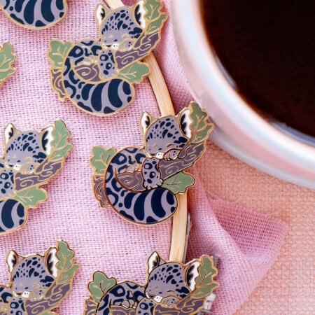 The cutest Clouded Leopard enamel pin badges! Each pin features a sleeping leopard on a tree branch. Cartoon art style, cozy aesthetic.