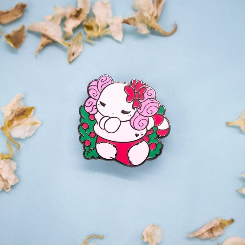 Festive "Lottie the Lotl" chibi axolotl holiday stocking enamel pin in black nickel, and red and green enamel